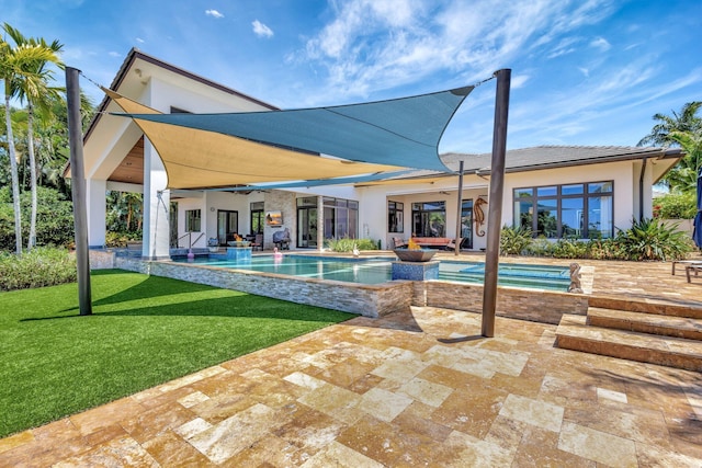 2783 Rhone Dr, Palm Beach Gardens, FL 33410 - back of house featuring a patio, an outdoor pool, stucco siding, and a lawn