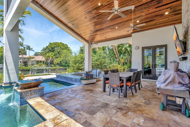 2783 Rhone Dr, Palm Beach Gardens, FL 33410 - view of patio featuring french doors, a jacuzzi, an outdoor pool, outdoor dining area, and ceiling fan