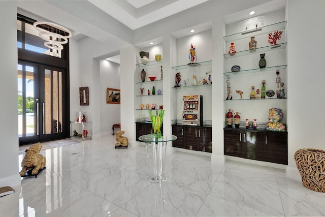 2783 Rhone Dr, Palm Beach Gardens, FL 33410 - foyer entrance featuring marble finish flooring, french doors, baseboards, recessed lighting, and a towering ceiling