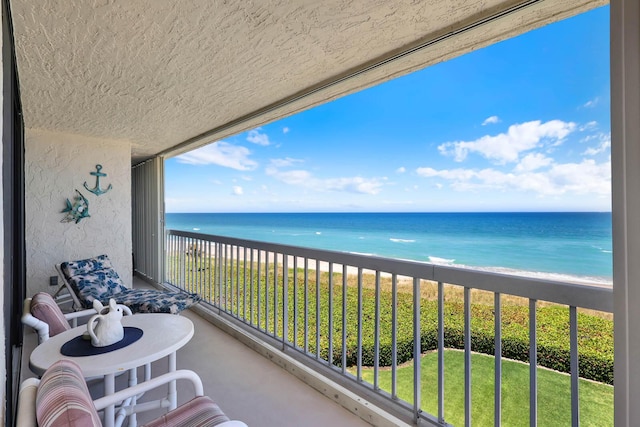 balcony featuring view of water and beach
