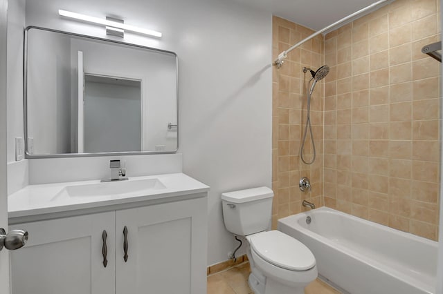 bathroom featuring toilet, vanity, bathtub / shower combination, tile patterned floors, and baseboards