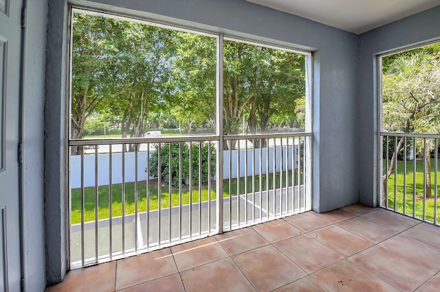 doorway to outside with tile patterned flooring