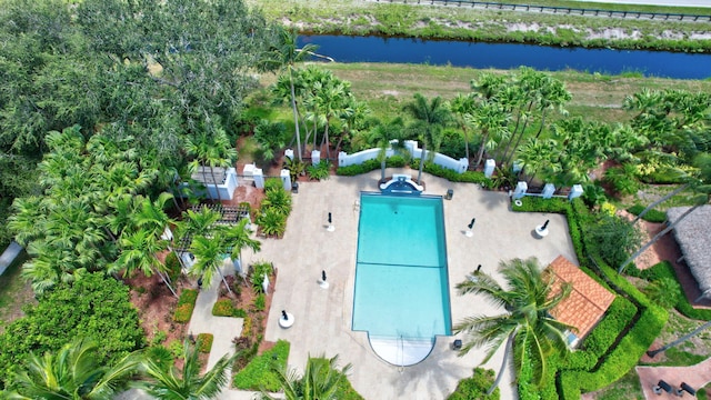 aerial view of property and surrounding area with a large body of water and a pool