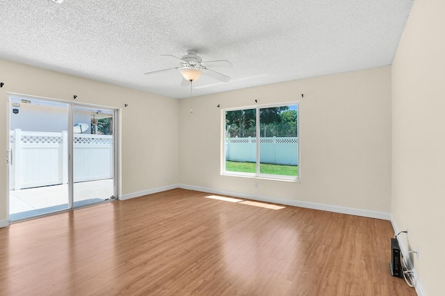 8074 Stirrup Cay Ct, Boynton Beach, FL 33436 - empty room featuring a ceiling fan, wood finished floors, baseboards, and a textured ceiling