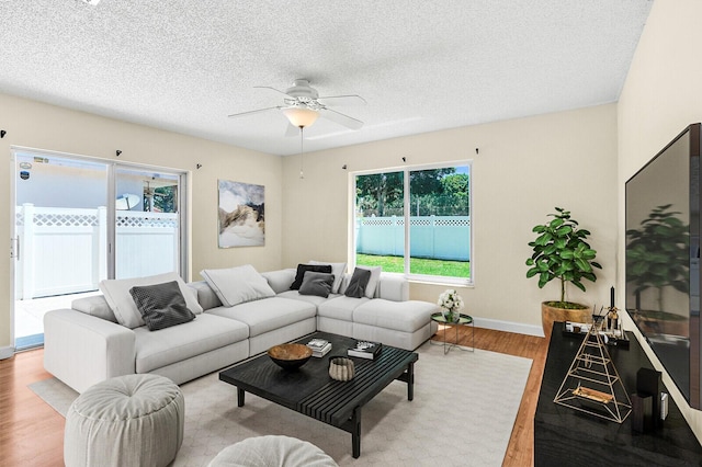 8074 Stirrup Cay Ct, Boynton Beach, FL 33436 - living room featuring wood finished floors, ceiling fan, a textured ceiling, and baseboards