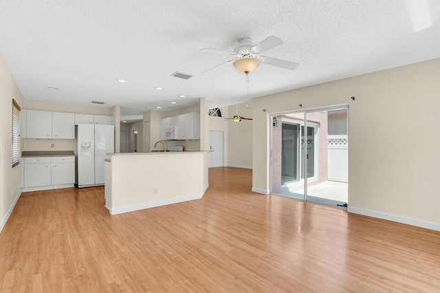 8074 Stirrup Cay Ct, Boynton Beach, FL 33436 - unfurnished living room featuring ceiling fan, light wood-style flooring, a textured ceiling, baseboards, and recessed lighting