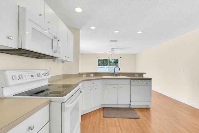 8074 Stirrup Cay Ct, Boynton Beach, FL 33436 - kitchen featuring white appliances, a sink, a ceiling fan, light wood-style flooring, and a peninsula