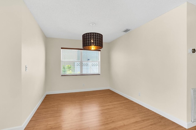 8074 Stirrup Cay Ct, Boynton Beach, FL 33436 - unfurnished room with light wood-style flooring, baseboards, and a textured ceiling