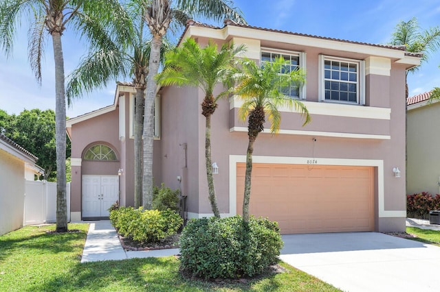 8074 Stirrup Cay Ct, Boynton Beach, FL 33436 - mediterranean / spanish home featuring an attached garage, stucco siding, and driveway