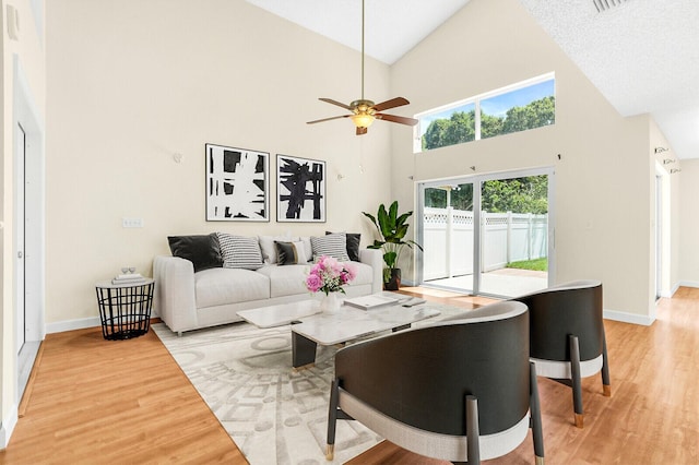 8074 Stirrup Cay Ct, Boynton Beach, FL 33436 - living area with light wood-style flooring, high vaulted ceiling, baseboards, and a ceiling fan