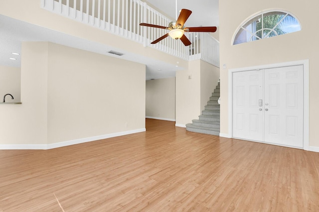 8074 Stirrup Cay Ct, Boynton Beach, FL 33436 - entrance foyer featuring a towering ceiling, ceiling fan, wood finished floors, baseboards, and stairway