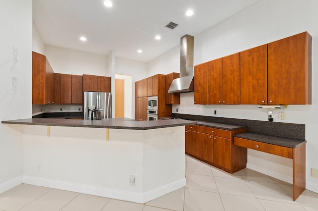 kitchen with appliances with stainless steel finishes, wall chimney exhaust hood, a peninsula, dark countertops, and recessed lighting