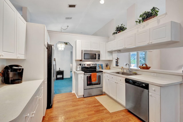 15550 73rd St N, The Acreage, FL 33470 - kitchen featuring stainless steel appliances, a sink, light countertops, light wood-style flooring, and white cabinetry
