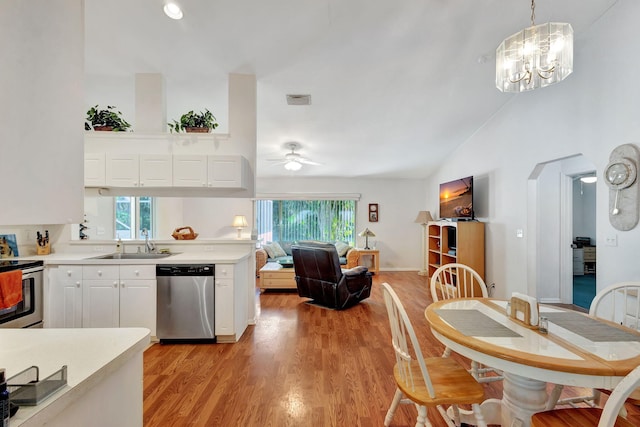 15550 73rd St N, The Acreage, FL 33470 - kitchen featuring stainless steel appliances, a sink, lofted ceiling, light wood-style floors, and light countertops