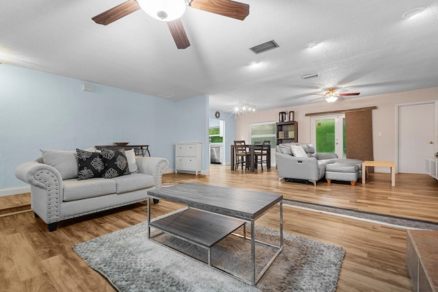 7503 NW 42nd St, Coral Springs, FL 33065 - living area with ceiling fan, healthy amount of natural light, light wood-type flooring, a textured ceiling, and baseboards