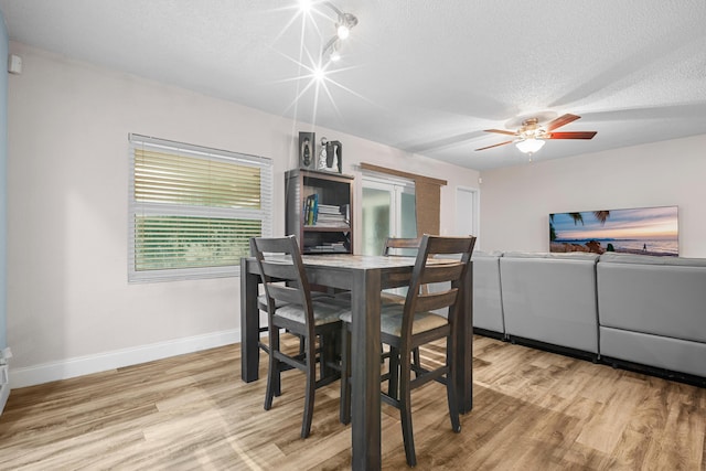 7503 NW 42nd St, Coral Springs, FL 33065 - dining room with baseboards, light wood-type flooring, a textured ceiling, and a ceiling fan