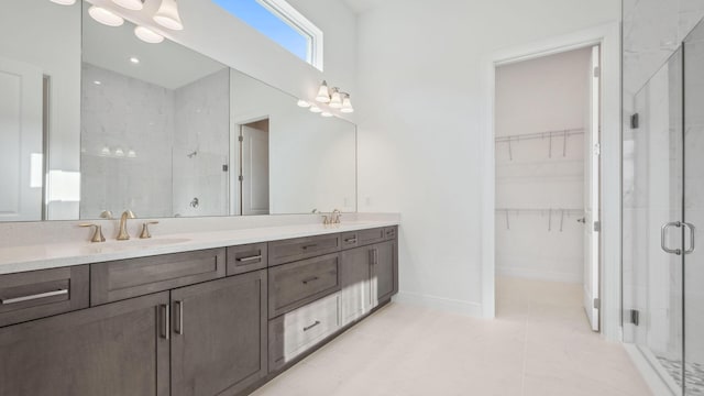 9143 SW Esule Way, Port Saint Lucie, FL 34987 - bathroom with a stall shower, a spacious closet, double vanity, tile patterned floors, and baseboards