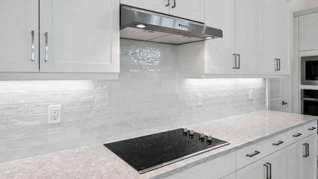 9143 SW Esule Way, Port Saint Lucie, FL 34987 - kitchen featuring under cabinet range hood, black electric stovetop, white cabinets, and decorative backsplash