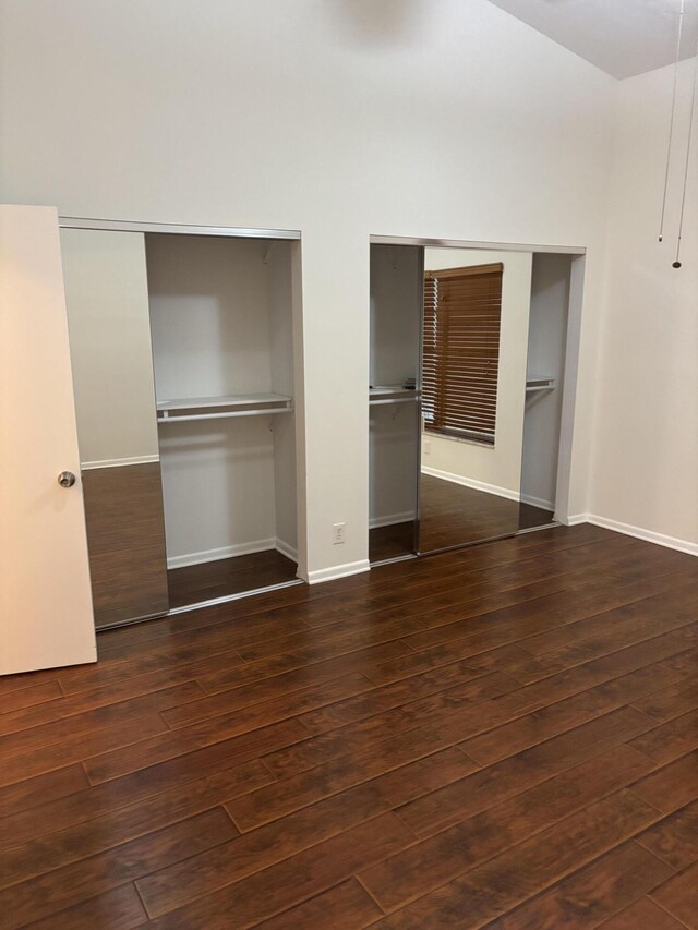 3962 Dafilee Cir, West Palm Beach, FL 33417 - unfurnished bedroom featuring two closets, wood-type flooring, and baseboards