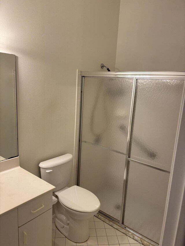 3962 Dafilee Cir, West Palm Beach, FL 33417 - bathroom with vanity, a stall shower, tile patterned flooring, and toilet