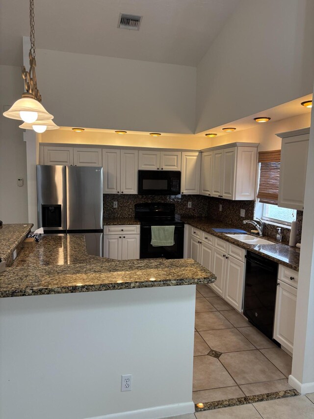 3962 Dafilee Cir, West Palm Beach, FL 33417 - kitchen with stainless steel refrigerator with ice dispenser, high vaulted ceiling, black microwave, tasteful backsplash, and dark stone counters