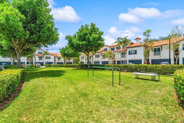 view of community featuring a residential view and a yard
