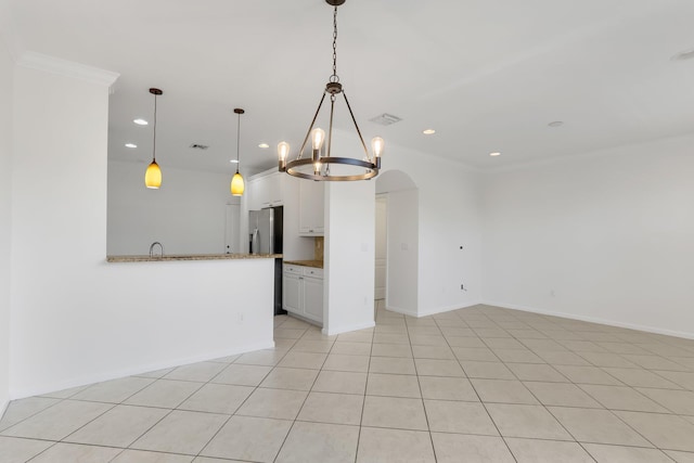empty room featuring a chandelier, recessed lighting, crown molding, baseboards, and a sink