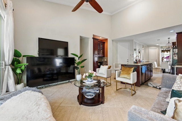 4635 Mediterranean Cir, Palm Beach Gardens, FL 33418 - living area featuring ornamental molding, light tile patterned floors, ceiling fan, a chandelier, and a towering ceiling