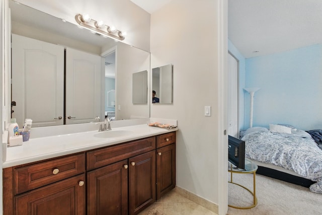 4635 Mediterranean Cir, Palm Beach Gardens, FL 33418 - bathroom featuring ensuite bathroom, vanity, tile patterned floors, and baseboards