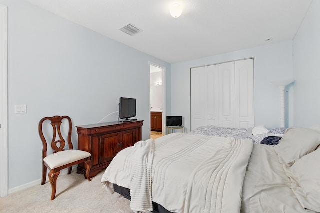 4635 Mediterranean Cir, Palm Beach Gardens, FL 33418 - bedroom with light carpet, a closet, baseboards, and ensuite bath