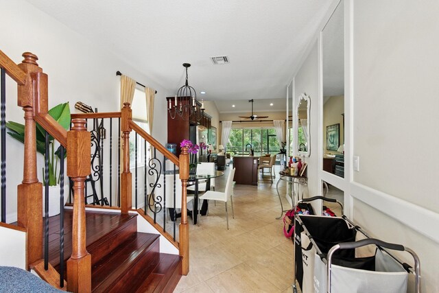 4635 Mediterranean Cir, Palm Beach Gardens, FL 33418 - stairs with tile patterned flooring, a chandelier, and recessed lighting