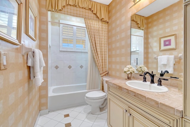 bathroom with wallpapered walls, tile patterned floors, plenty of natural light, toilet, and vanity