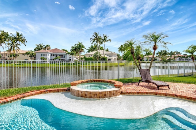 view of swimming pool featuring a pool with connected hot tub, fence, a patio, and a water view