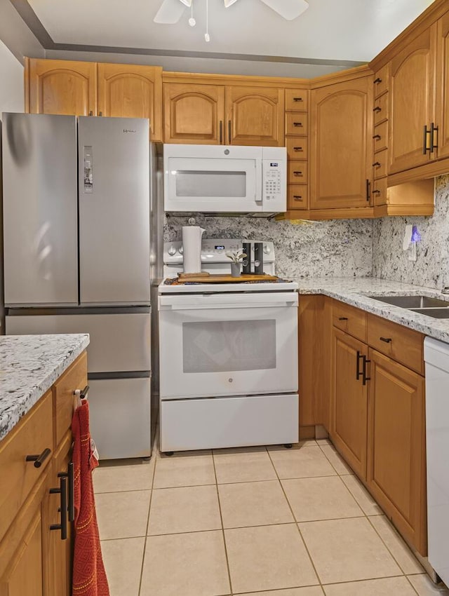 226 Northampton L Unit 226, West Palm Beach, FL 33417 - kitchen with white appliances, light tile patterned flooring, light stone countertops, and tasteful backsplash