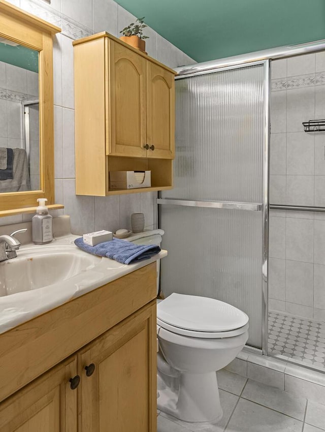 226 Northampton L Unit 226, West Palm Beach, FL 33417 - full bathroom featuring a shower stall, toilet, vanity, tile walls, and tile patterned floors