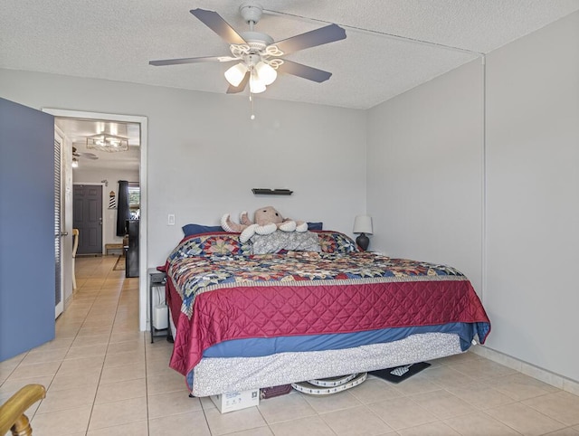 226 Northampton L Unit 226, West Palm Beach, FL 33417 - bedroom with light tile patterned floors, a textured ceiling, and a ceiling fan
