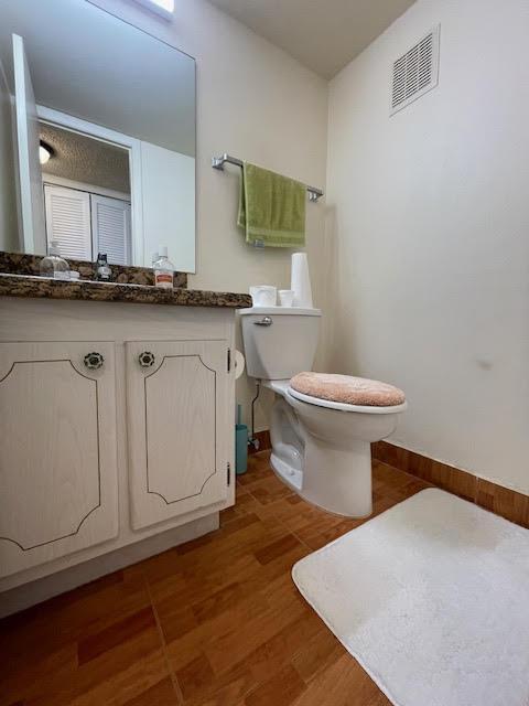 196 Upminster L Unit 196, Deerfield Beach, FL 33442 - bathroom featuring toilet, vanity, and baseboards