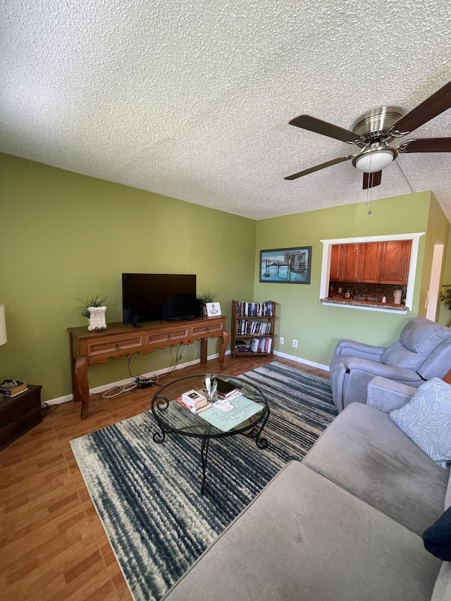196 Upminster L Unit 196, Deerfield Beach, FL 33442 - living room with a ceiling fan, baseboards, and a textured ceiling