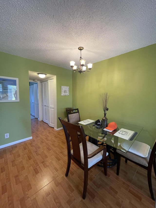196 Upminster L Unit 196, Deerfield Beach, FL 33442 - dining room with a chandelier, wood finished floors, a textured ceiling, and baseboards