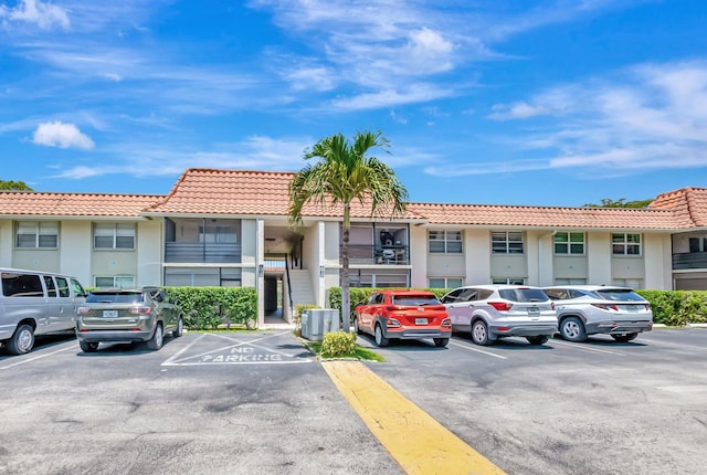 1124 NW 13th St Unit 208, Boca Raton, FL 33486 - view of property featuring uncovered parking and central AC unit