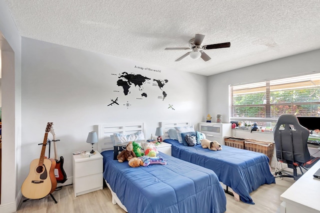 1124 NW 13th St Unit 208, Boca Raton, FL 33486 - bedroom featuring a textured ceiling, light wood-style floors, and ceiling fan