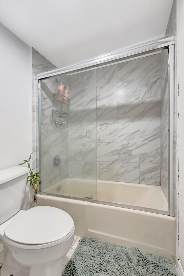 1124 NW 13th St Unit 208, Boca Raton, FL 33486 - bathroom featuring combined bath / shower with glass door, toilet, and tile patterned floors