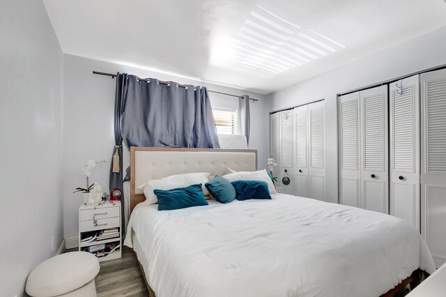 1124 NW 13th St Unit 208, Boca Raton, FL 33486 - bedroom featuring wood finished floors and two closets