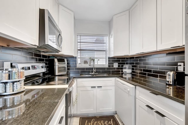 1124 NW 13th St Unit 208, Boca Raton, FL 33486 - kitchen featuring stainless steel appliances, a sink, white cabinetry, and dark stone countertops