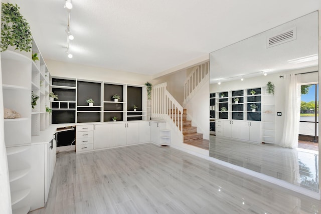 1388 Garden Rd, Weston, FL 33326 - unfurnished living room with track lighting, stairway, and an office area