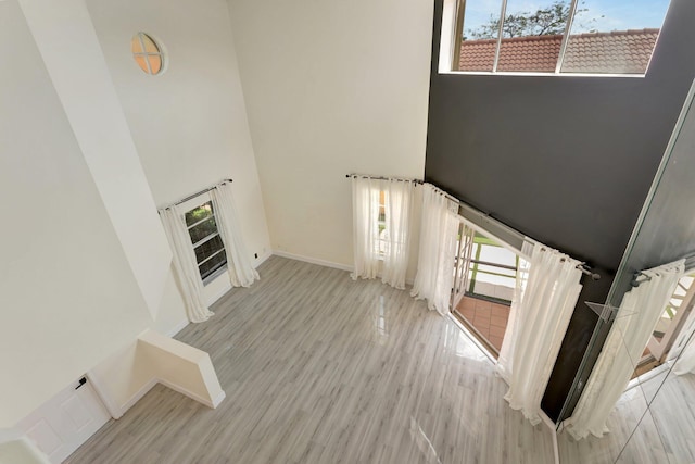 1388 Garden Rd, Weston, FL 33326 - staircase featuring a towering ceiling, plenty of natural light, and wood finished floors