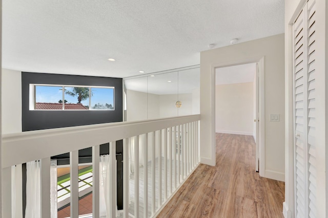 1388 Garden Rd, Weston, FL 33326 - hall featuring light wood-style flooring, a textured ceiling, and recessed lighting