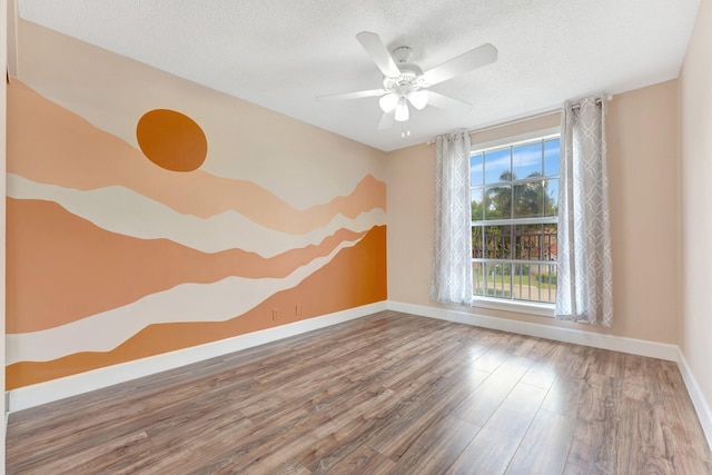 1388 Garden Rd, Weston, FL 33326 - unfurnished room with wood finished floors, ceiling fan, and a textured ceiling