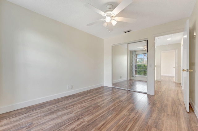 1388 Garden Rd, Weston, FL 33326 - unfurnished bedroom featuring wood finished floors, a closet, and a ceiling fan
