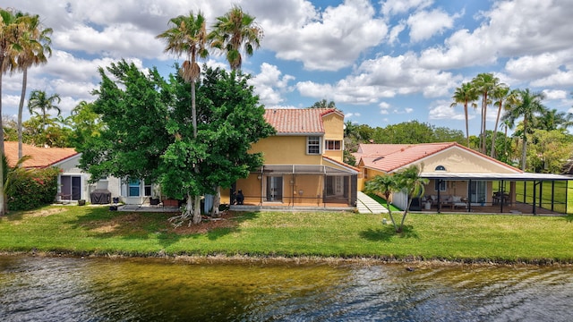 1388 Garden Rd, Weston, FL 33326 - back of property featuring a tile roof, a water view, a patio area, and stucco siding